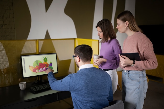 Medium shot people looking at computer