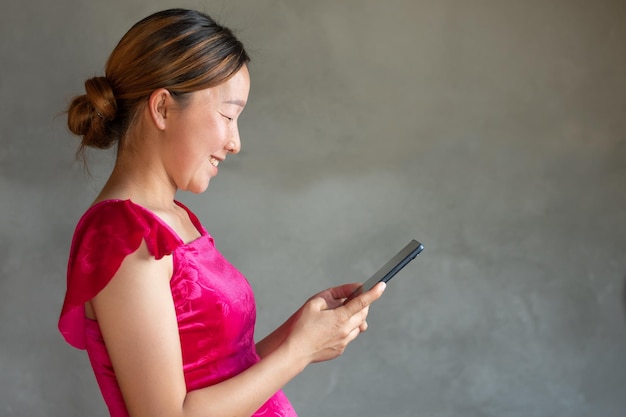 A medium shot of pregnancy women is video call with doctor on her mobile with smiling