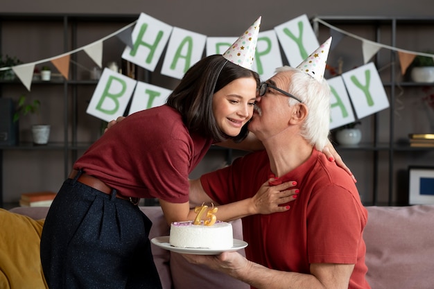 Medium shot senior man kissing woman