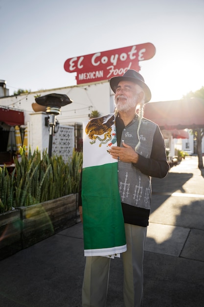 Medium shot senior man with mexican flag