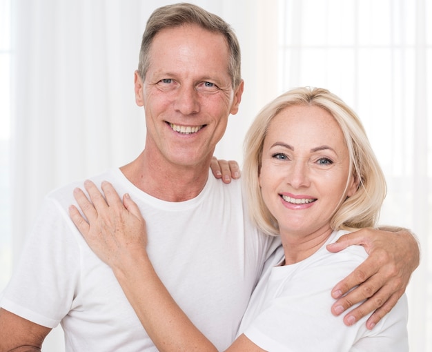 Medium shot smiley couple posing together