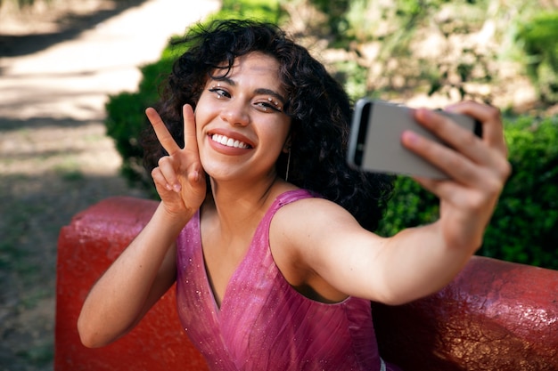 Medium shot smiley girl taking selfie