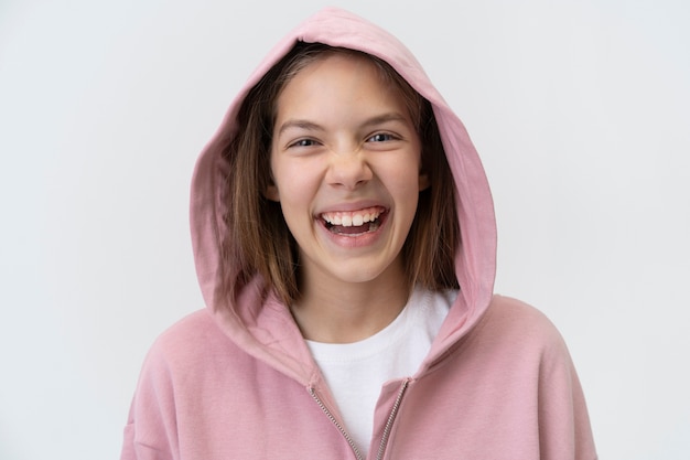 Medium shot smiley girl wearing hoodie