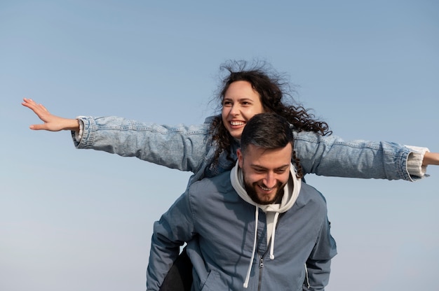 Medium shot smiley man carrying woman