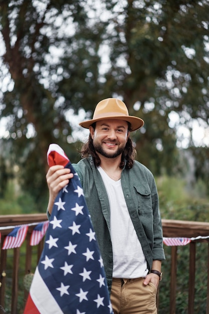 Medium shot smiley man holding usa flag