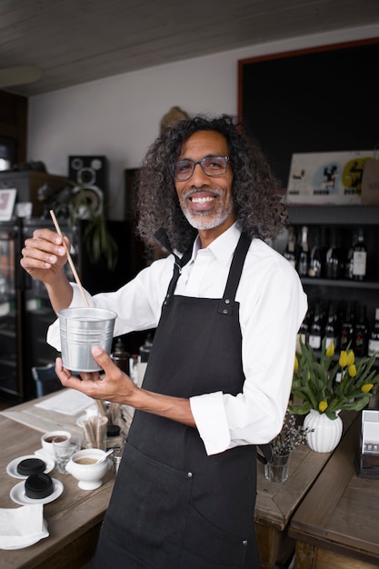 Medium shot smiley man making coffee