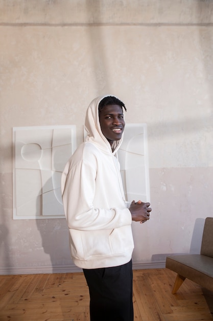 Medium shot smiley man with hoodie indoors