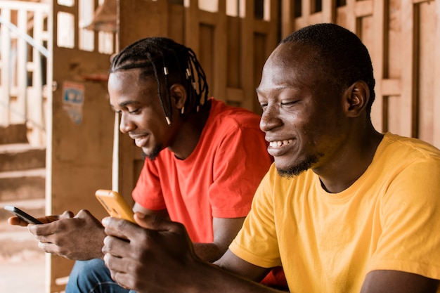 Medium shot smiley men with smartphones