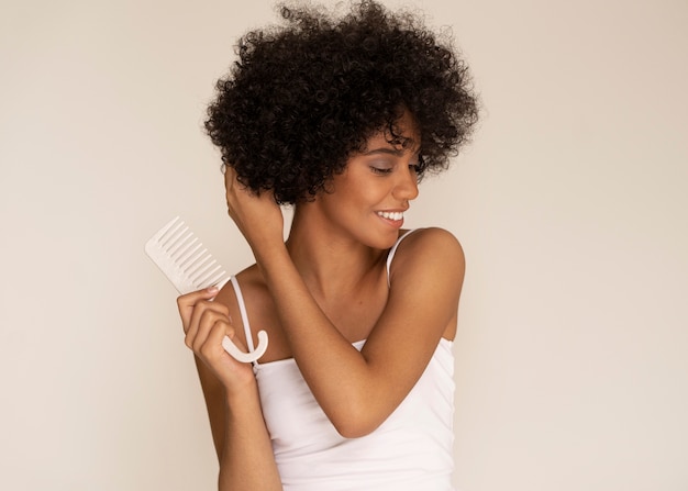 Medium shot smiley woman holding comb