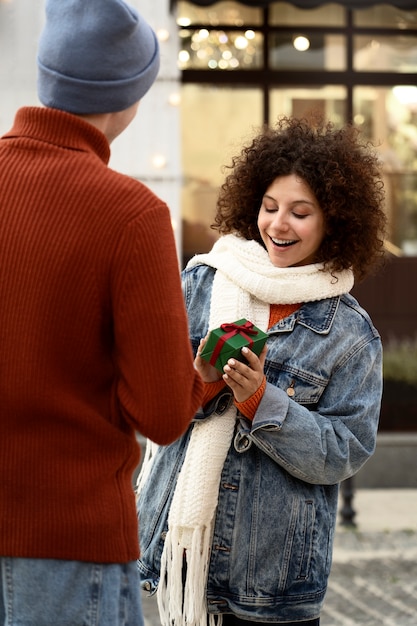 Medium shot smiley woman receiving gift