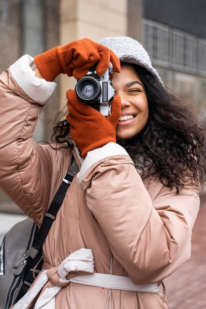 Medium shot smiley woman taking photos