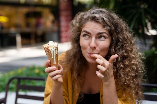 Medium shot smiley woman with ice cream cone