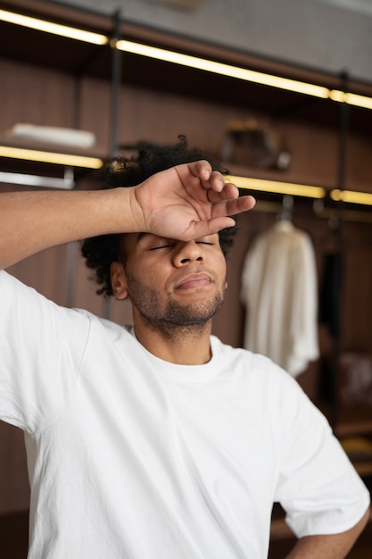 Medium shot tired man in closet