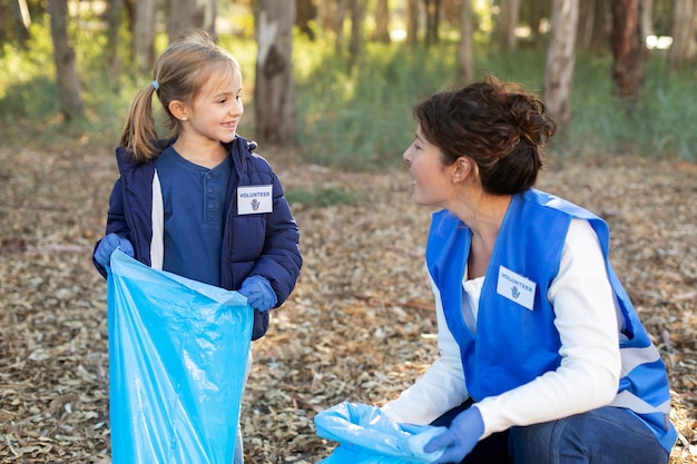 Medium shot volunteers helping environment