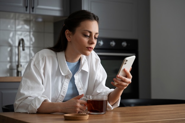 Medium shot woman addicted to smartphone