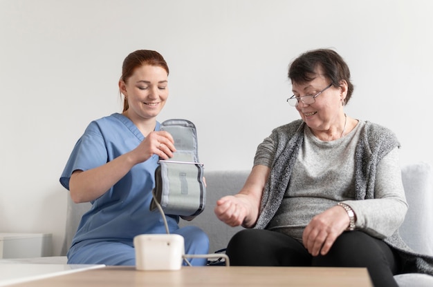 Medium shot woman checking patient