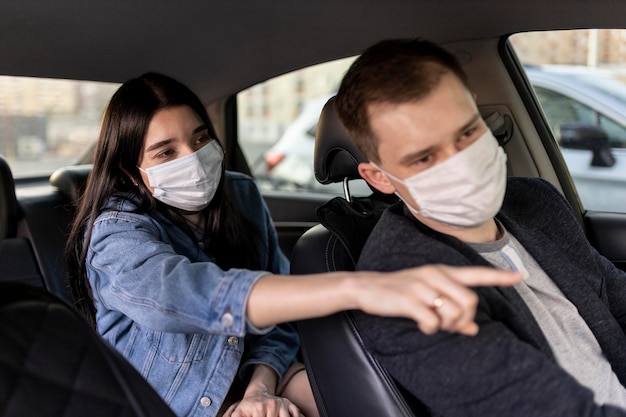 Medium shot woman and driver with mask