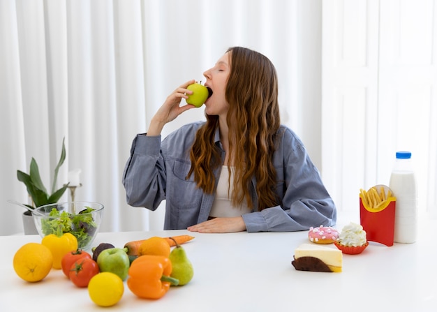 Medium shot woman eating apple