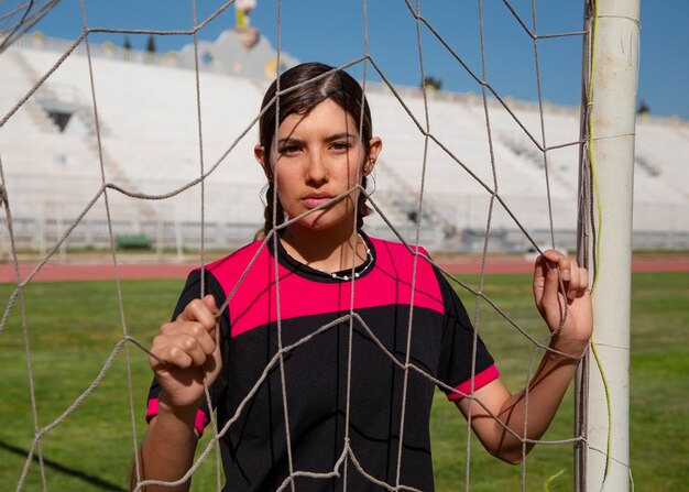 Medium shot woman football player on field