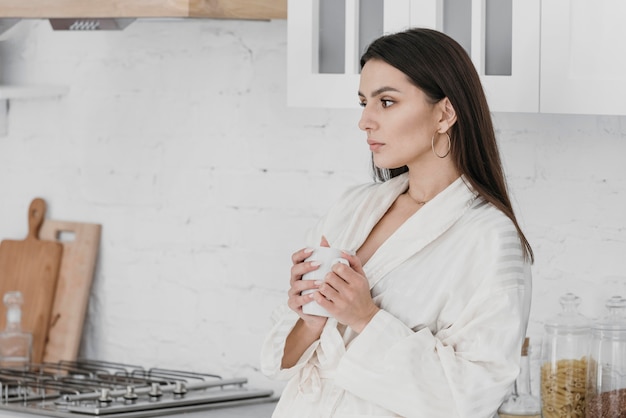 Medium shot woman holding cup