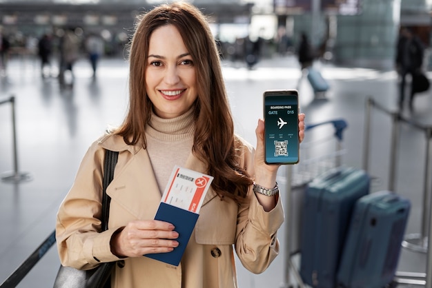 Medium shot woman holding smartphone