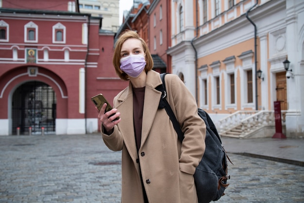 Medium shot woman holding smartphone