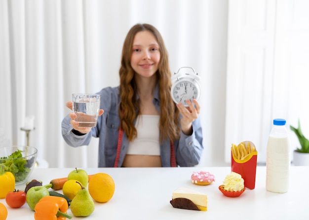 Medium shot woman holding water glass