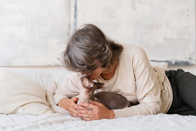 Medium shot woman kissing cat