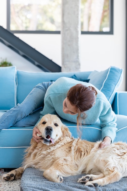 Medium shot woman playing with dog