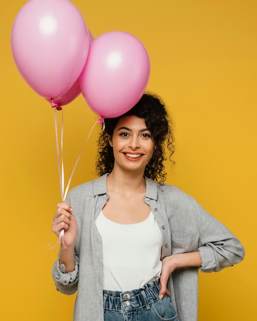 Medium shot woman posing with balloons