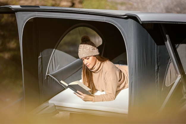 Medium shot woman reading book