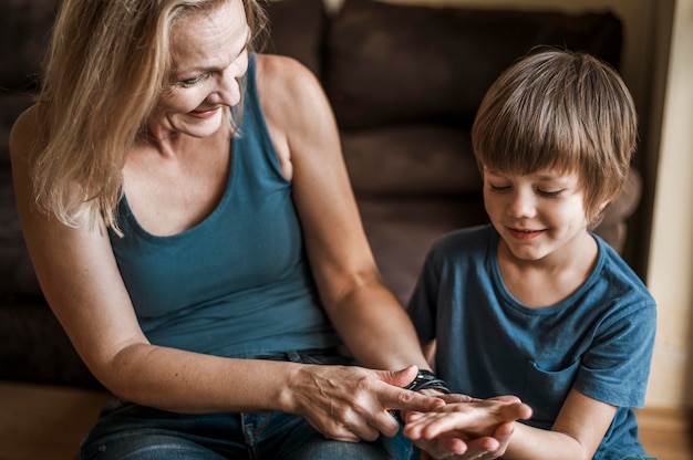 Medium shot woman reading kid's palm