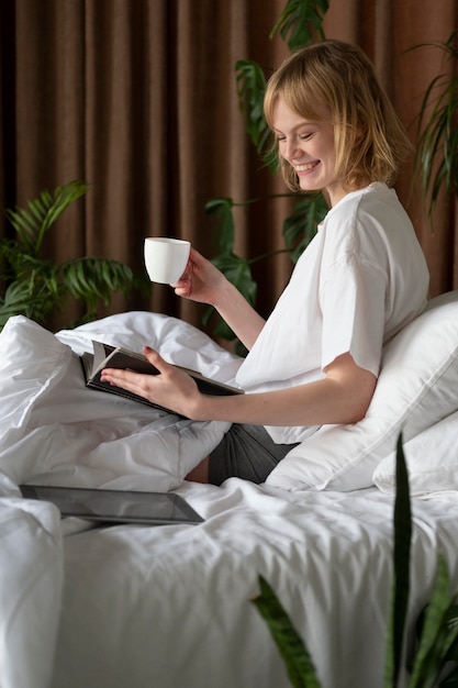 Medium shot woman sitting in bed