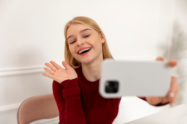 Medium shot woman taking selfie