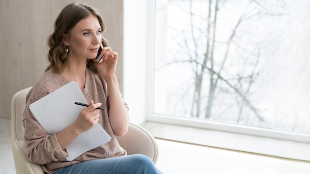 Medium shot woman talking on phone