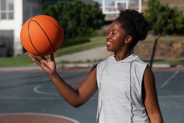 Medium shot woman training for basketball