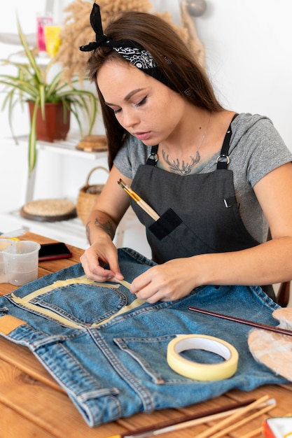 Medium shot woman using tape