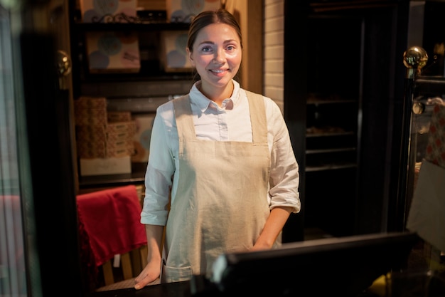 Medium shot woman wearing apron