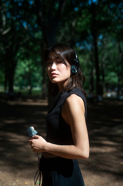 Medium shot woman wearing headphones