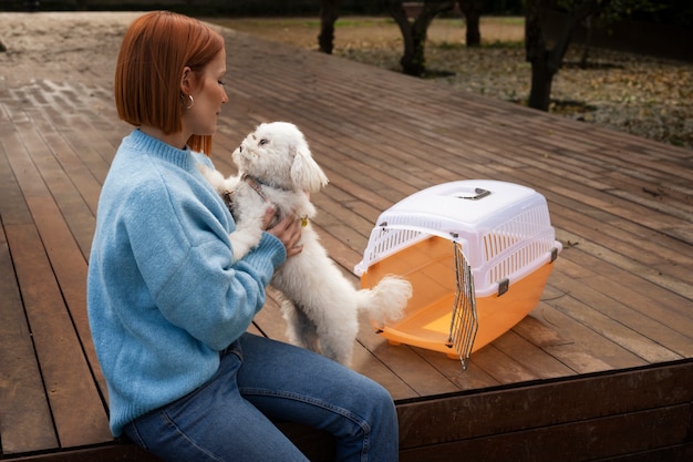 Medium shot woman with pet carrier