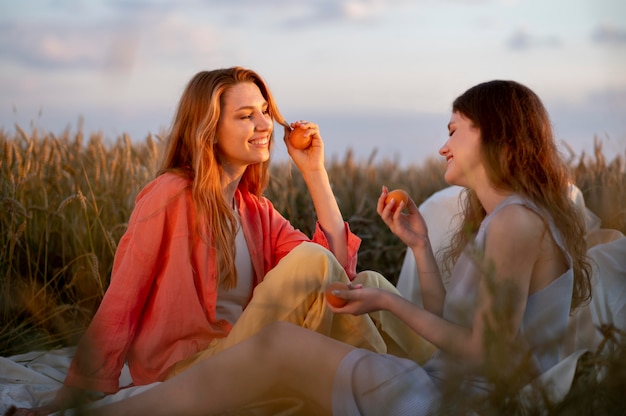 Medium shot women holding fruits