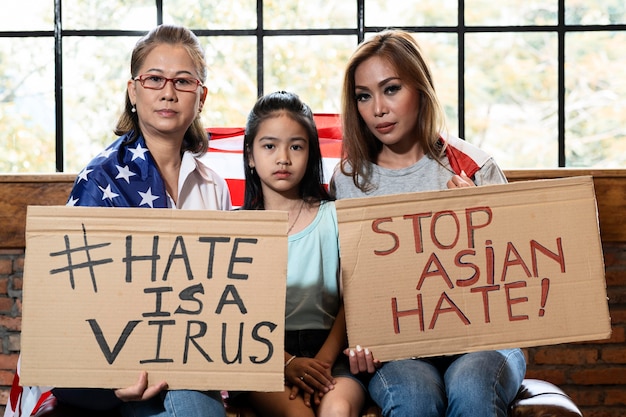 Medium shot women and kid with placards