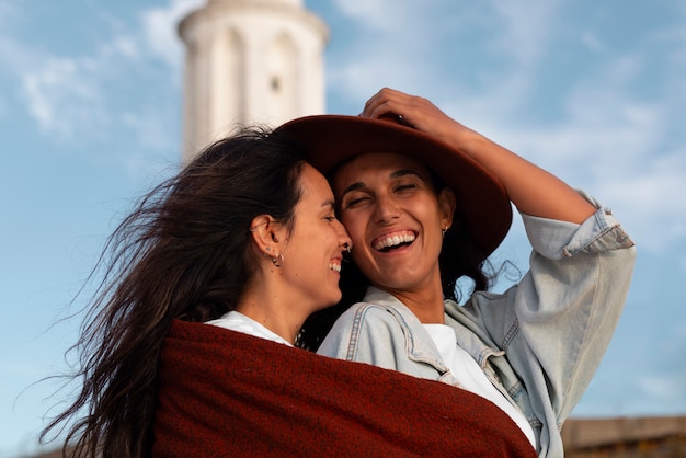 Medium shot women posing with lighthouse