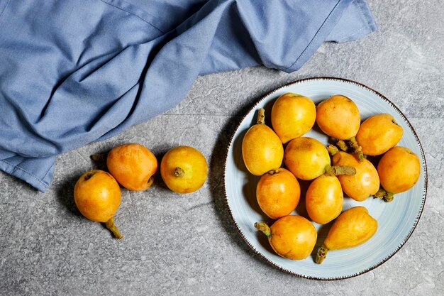 Medlar Fruit Bunch of Loquats in plate Group of Japanese Orange Fruit Medlars Exotic Juicy Sweet