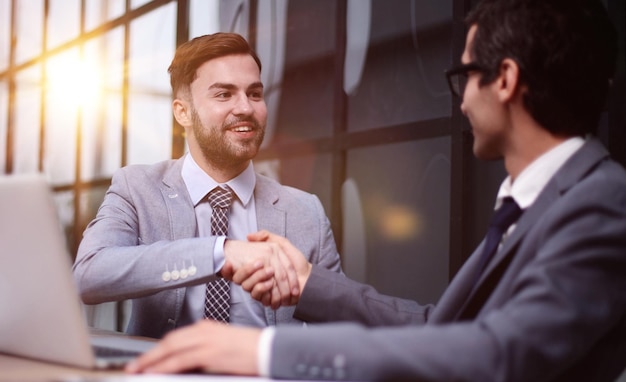 Meeting handshake and cooperation in the office for a deal or agreement