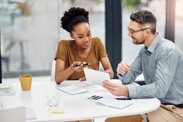 Meeting woman and man with tablet in office for connection communication and discussion Businesspeople coworkers and technology in talking for information internet and online as project manager