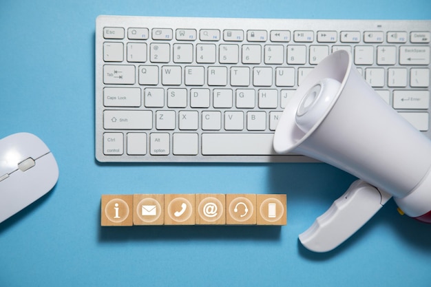 Megaphone with wooden cubes on the blue background Social Media