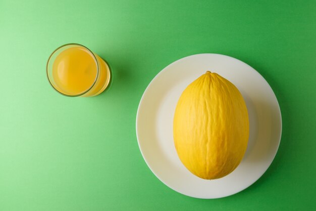 Melon on bright green surface.