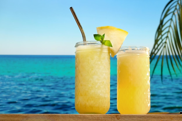 Melon lemonade on table bar tropical sea on background