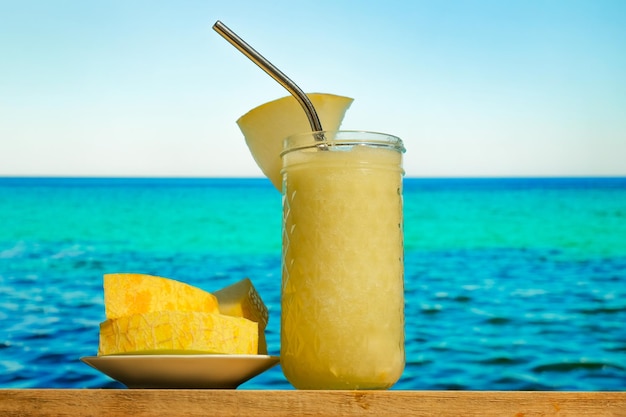 Melon smoothie blue sea on background